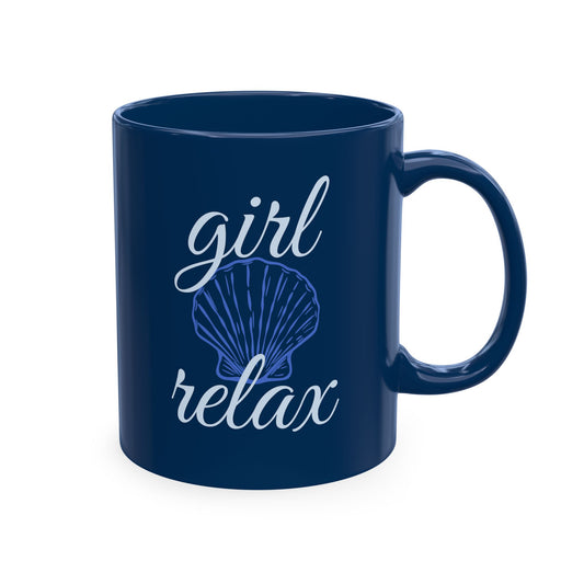 Navy blue ceramic mug with elegant light-blue “Girl Relax” lettering and a delicate seashell illustration.



