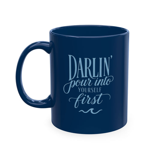 Navy blue ceramic self-care mug with elegant light blue lettering that says “Darlin’ pour into yourself first” and a wave accent.